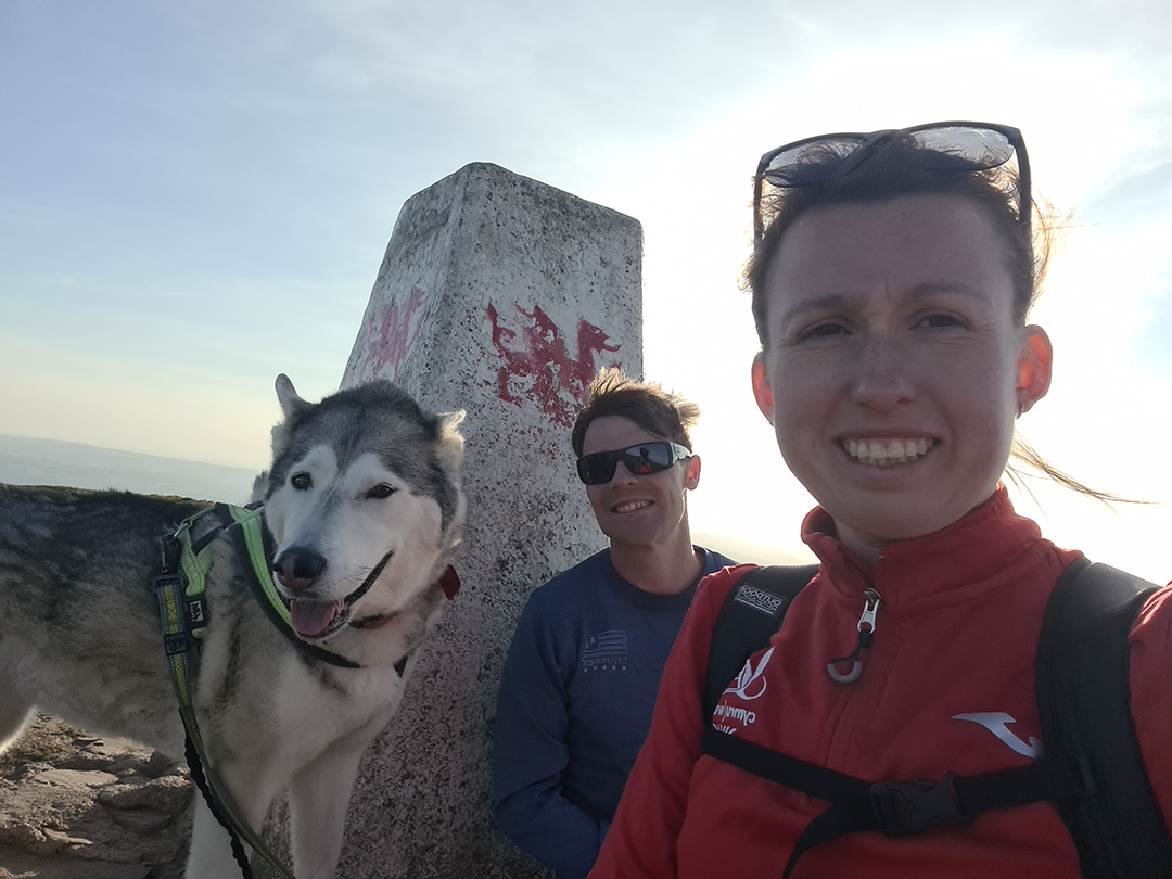 Clara with her finance and dog climbing The Garth.